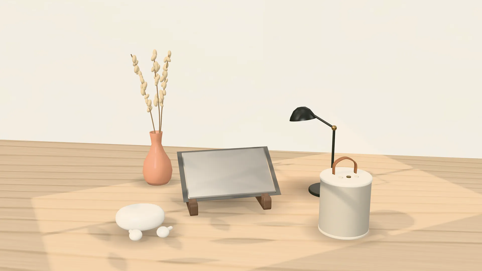 A laptop stand, desk lamp, speaker, earbuds and a vase of dried stems on an oak table in window light.